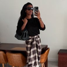 Influencer @nlmarilyn wears COS wrap checked skirt.
