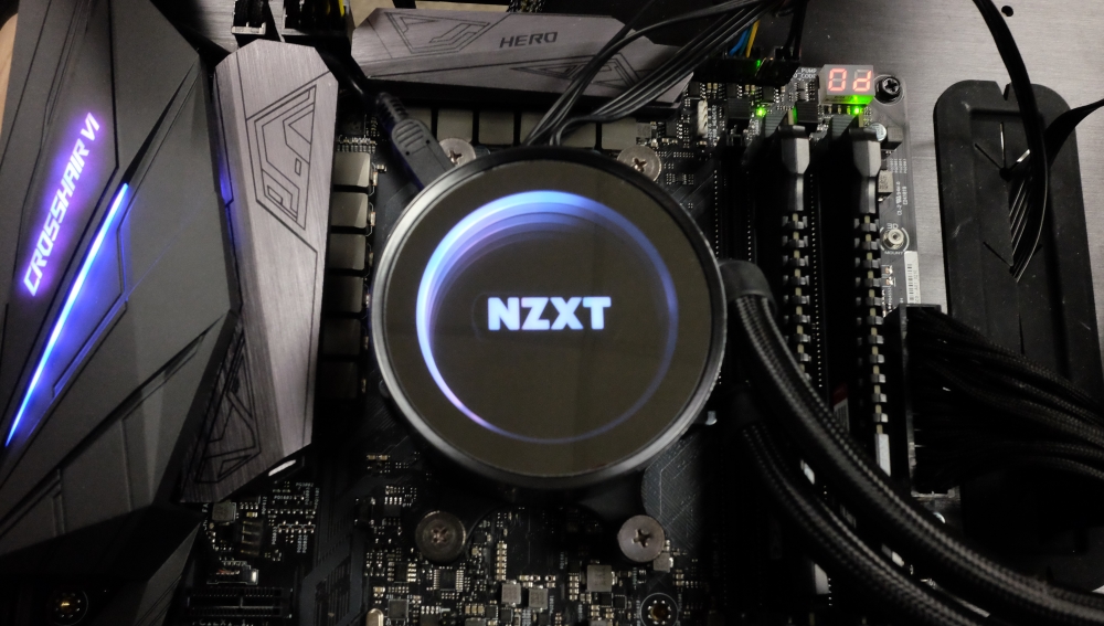 Close-up of an NZXT-branding all-in-one liquid CPU cooler fitted to a motherboard.