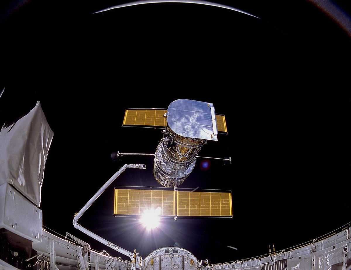 The Hubble Space Telescope, seen from the space shuttle Discovery during the observatory&#039;s deployment on April 25, 1990.