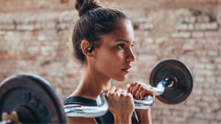JBL Endurance Zone worn by a lady lifting weights