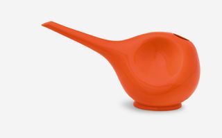 An orange watering can by Hedwig Bollhagen