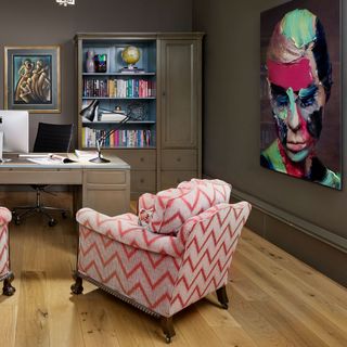 study with patterned upholstered chair and contemporary artwork