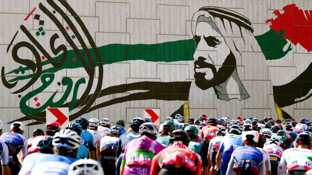 AL MARJAN UNITED ARAB EMIRATES FEBRUARY 24 general view of the peloton competing with graffiti in the background of Sheikh Zayed Bin Sultan Al Nahyan during the 4th UAE Tour 2022 Stage 5 a 182km stage from Ras al Khaimah Corniche to Al Marjan Island UAETour WorldTour on February 24 2022 in Al Marjan United Arab Emirates Photo by Tim de WaeleGetty Images