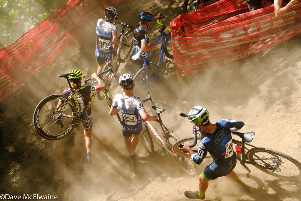 Anthony Clark, Lance Haidat, and others running in clouds of dust