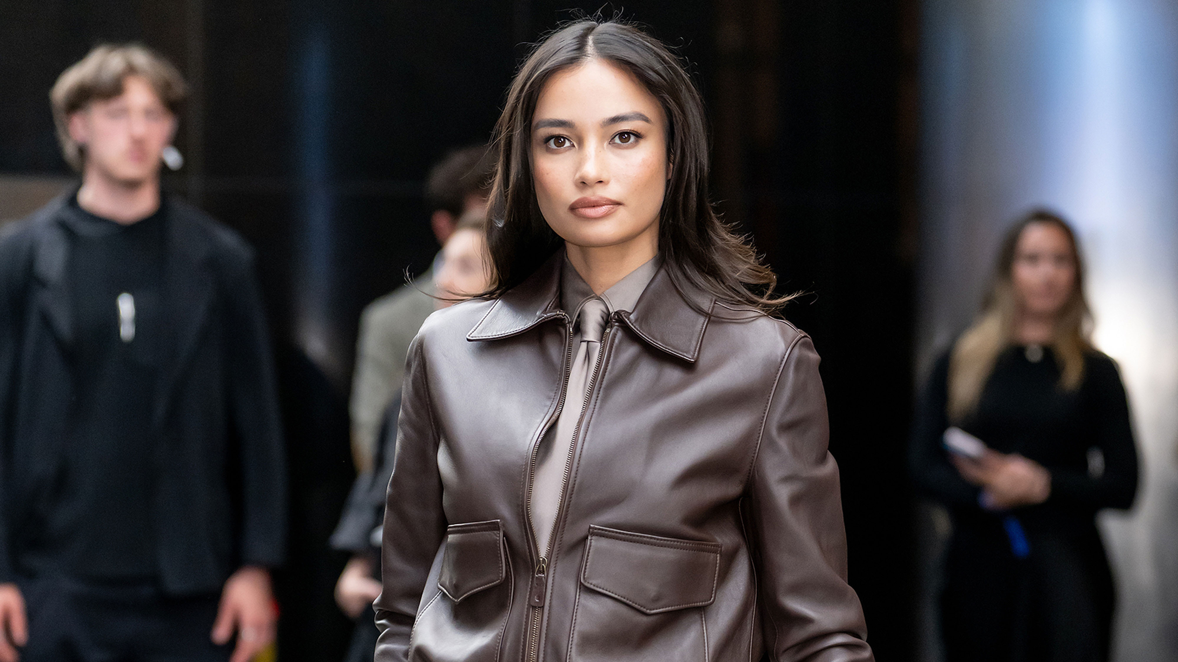 Woman wearing a bomber jacket outfit.