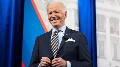 US President Joe Biden holds a face mask as he participates in a CNN town hall at the Pabst Theater in Milwaukee, Wisconsin, February 16, 2021