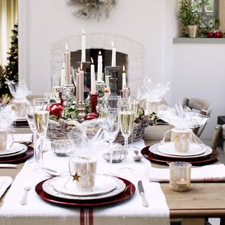 chritsmas table decorations in a white room with candles