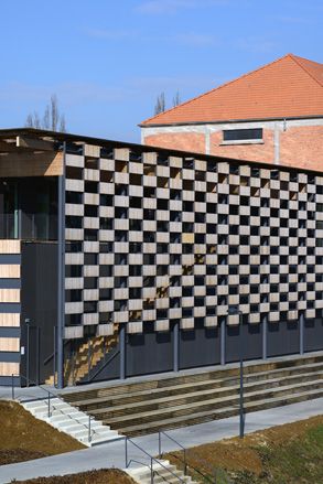 The Besançon design consists of two long, low structures with checkerboard wood, glass and aluminium façades.