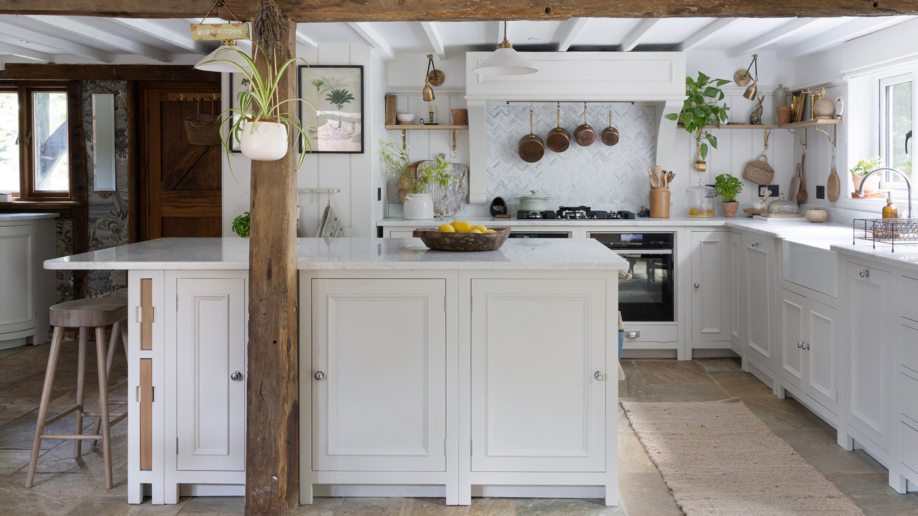 white preloved kitchen with island and oven reinstalled in an oast house