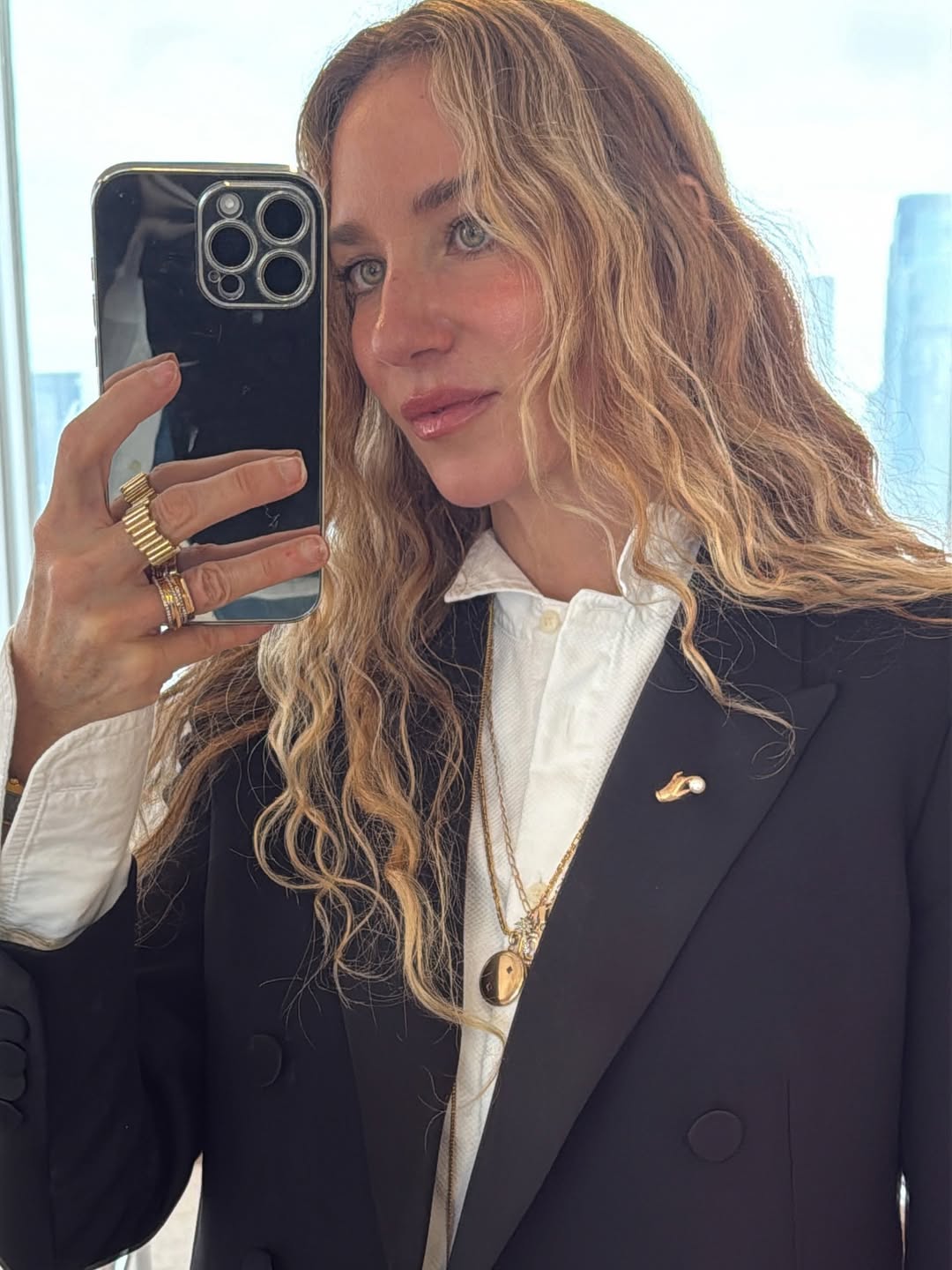 @olympiamarie wears black blazer and brooch