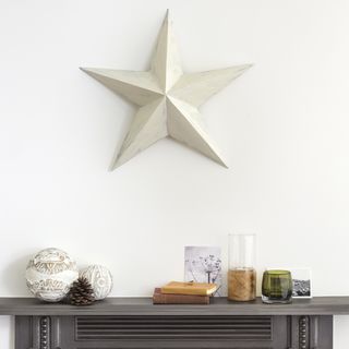 white walls star on wall black table with books