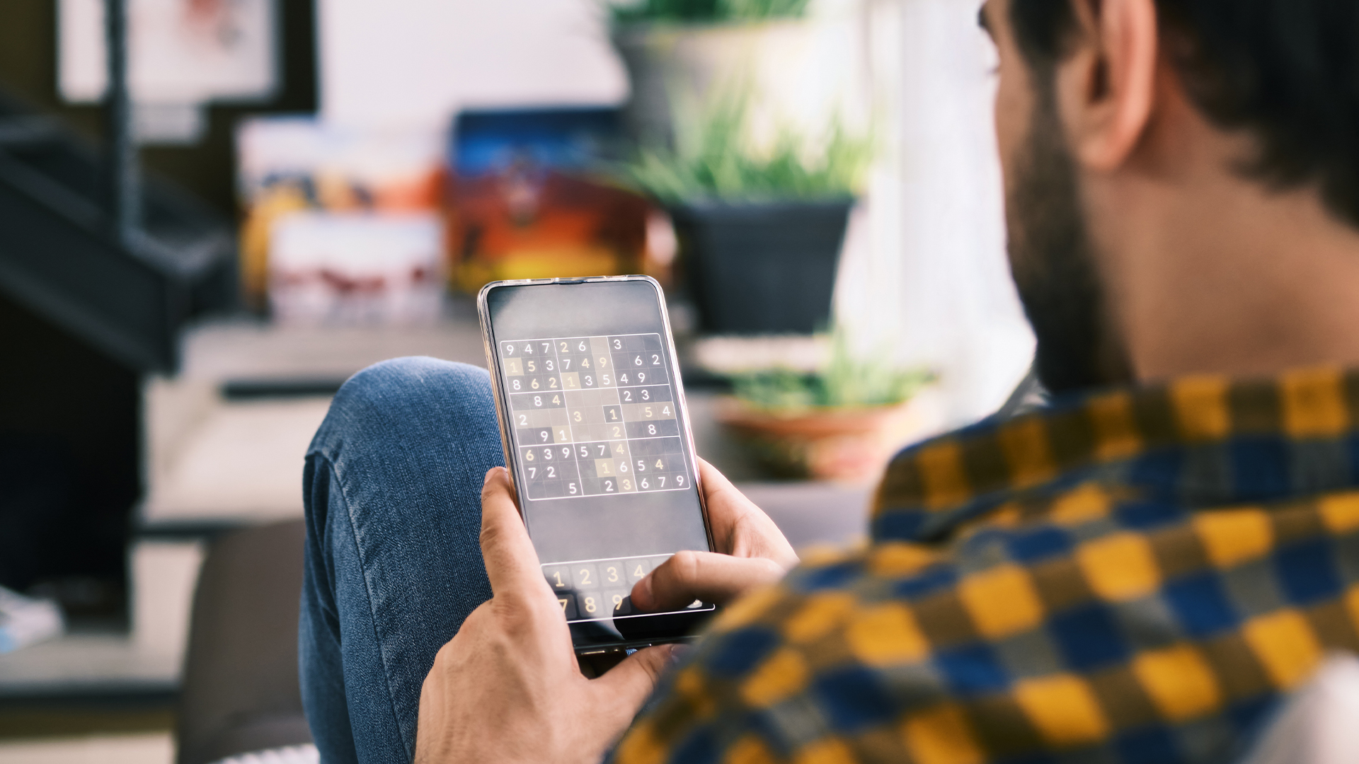 A man plays a game on his phone