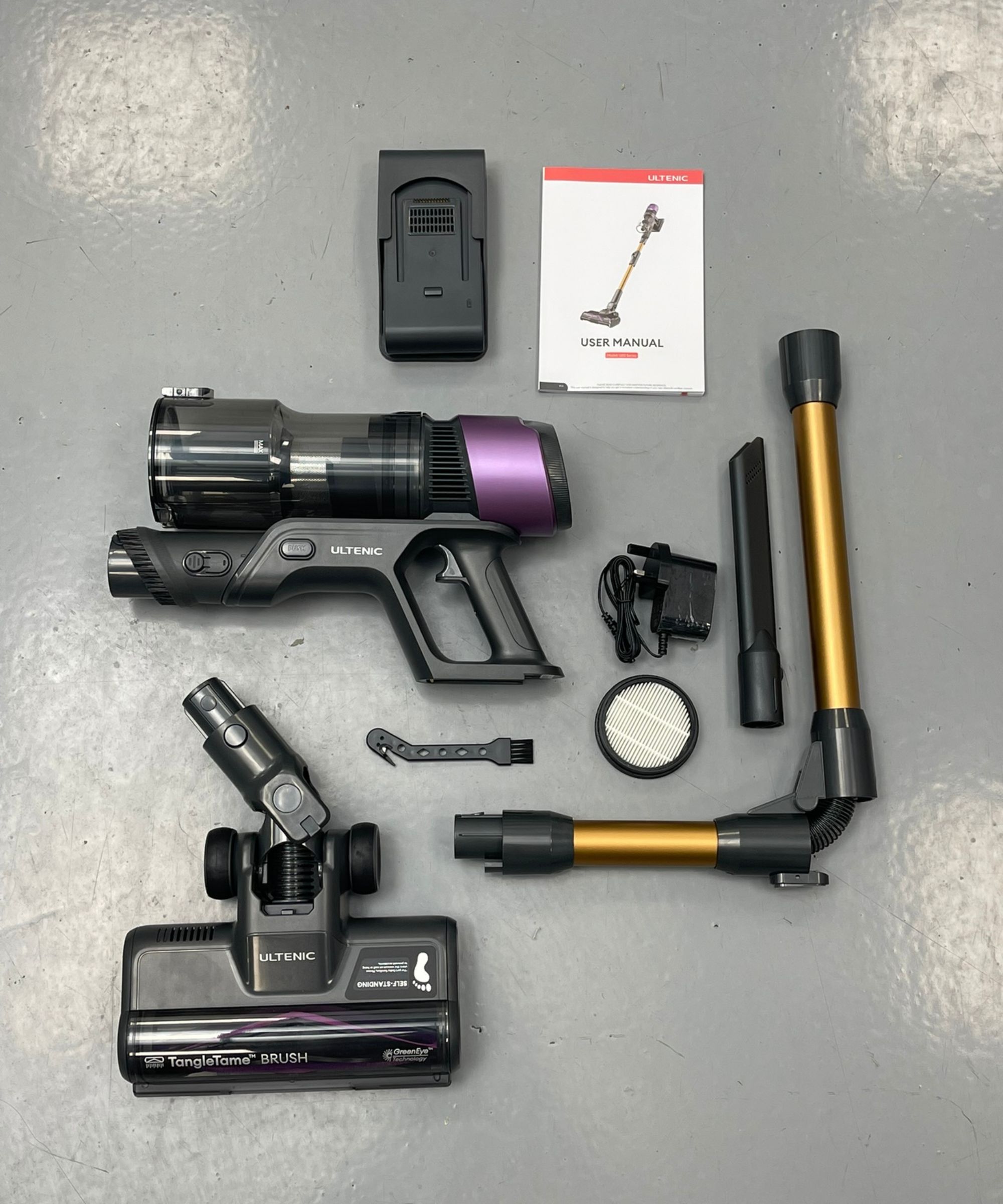 All parts of the Ultenic U20 cordless vacuum laid out on linoleum floor in Future test center.