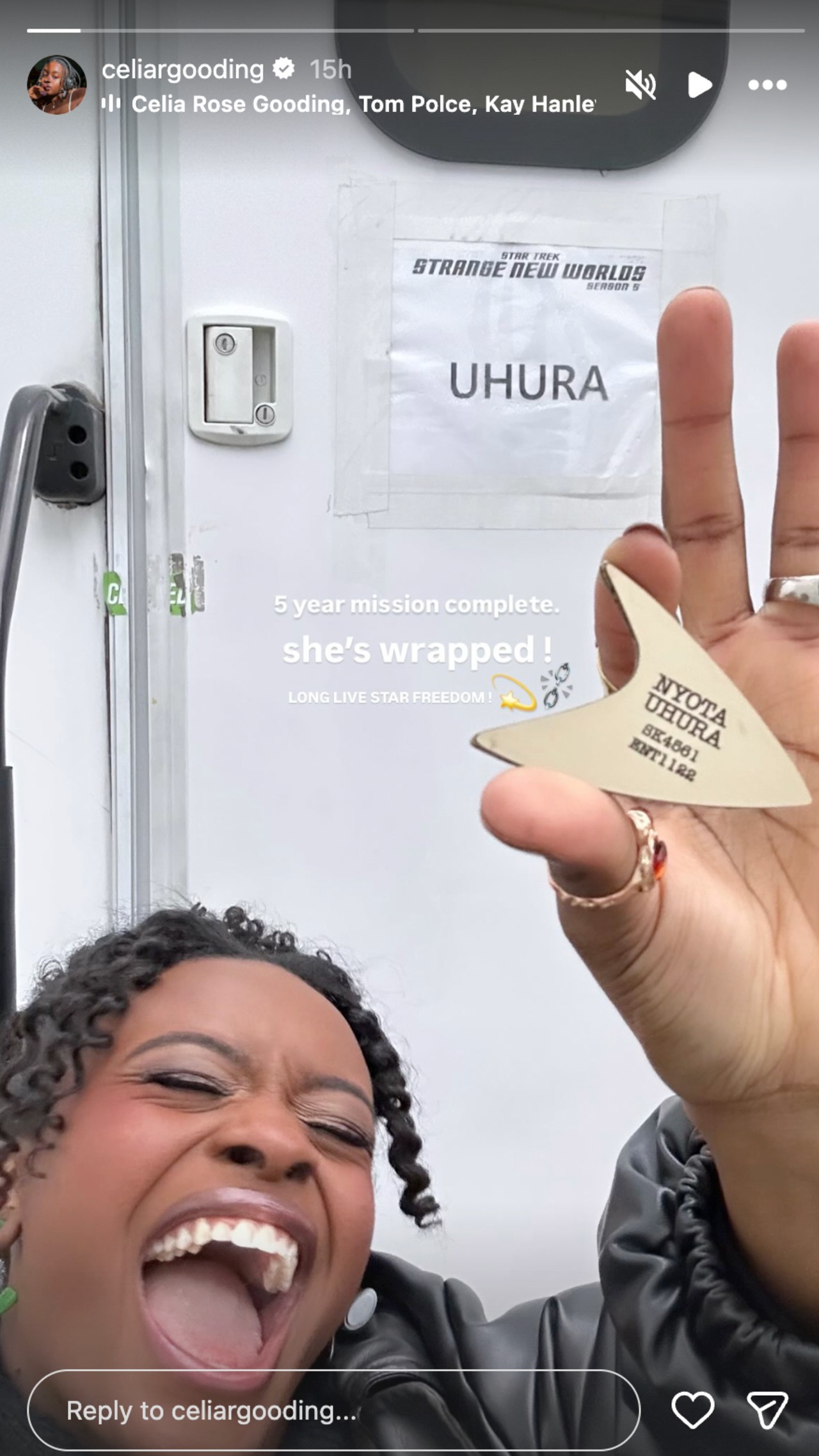 celia Rose Gooding celebrating wrapping on Star Trek: Strange New Worlds with her mouth open and a comm badge in hand