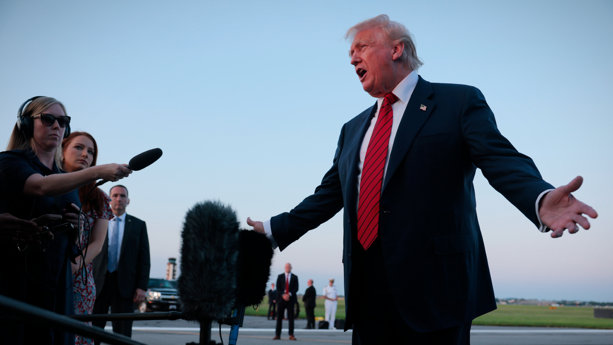 Donald Trump talks to reporters on tarmac