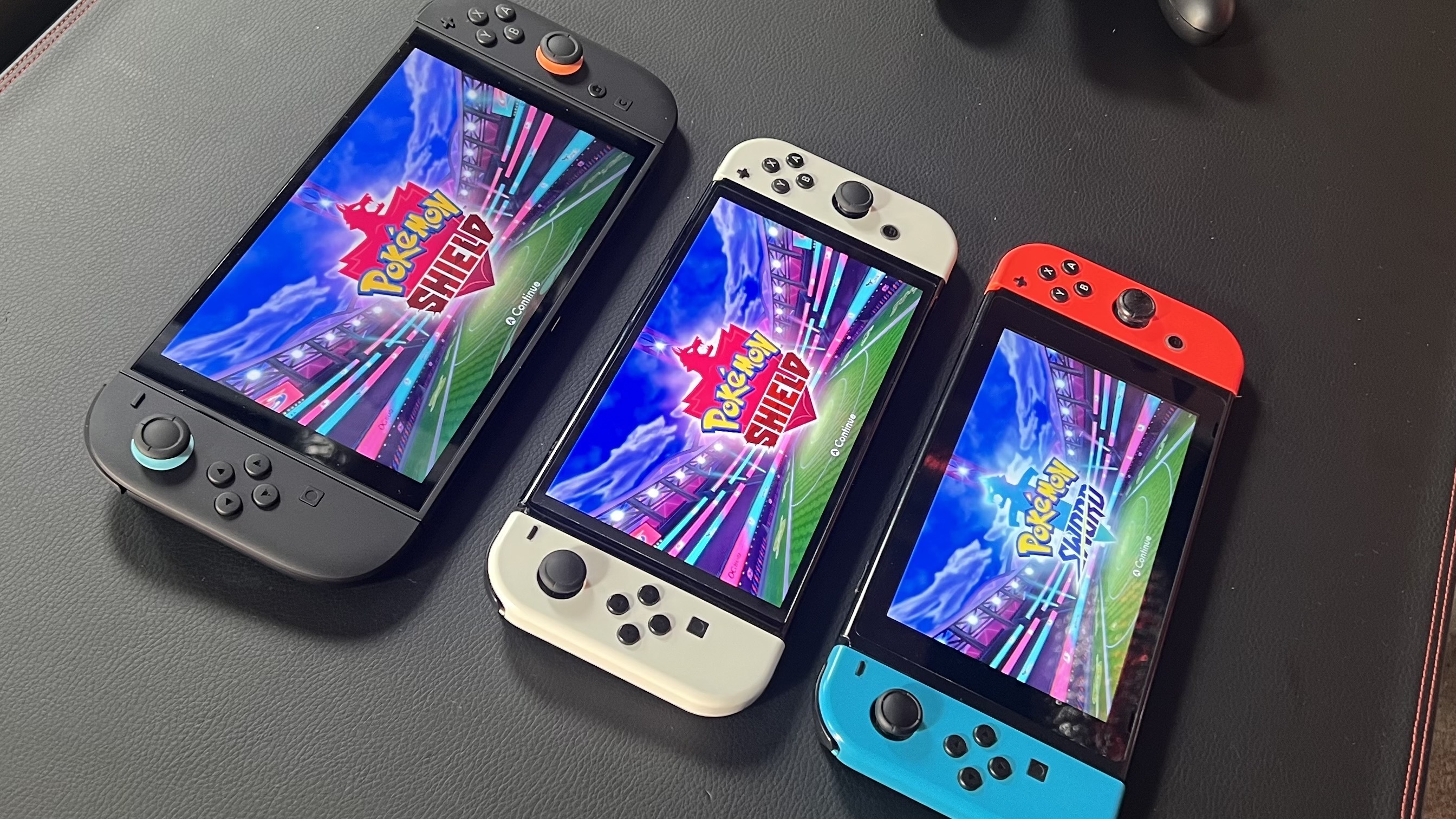 Nintendo Switch 2, Nintendo Switch OLED, and Nintendo Switch running Pokemon Shield and Sword