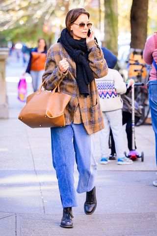 Katie Holmes wearing jeans and a plaid shirt.