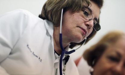 Dr. Martha Perez examines a patient at a Florida health clinic in February.