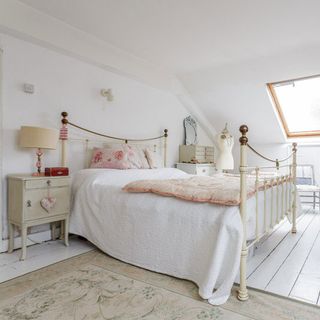 guest bedroom with white wall and lamp on bedside table