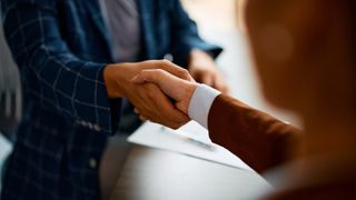 Close up of business people shaking hands in the office