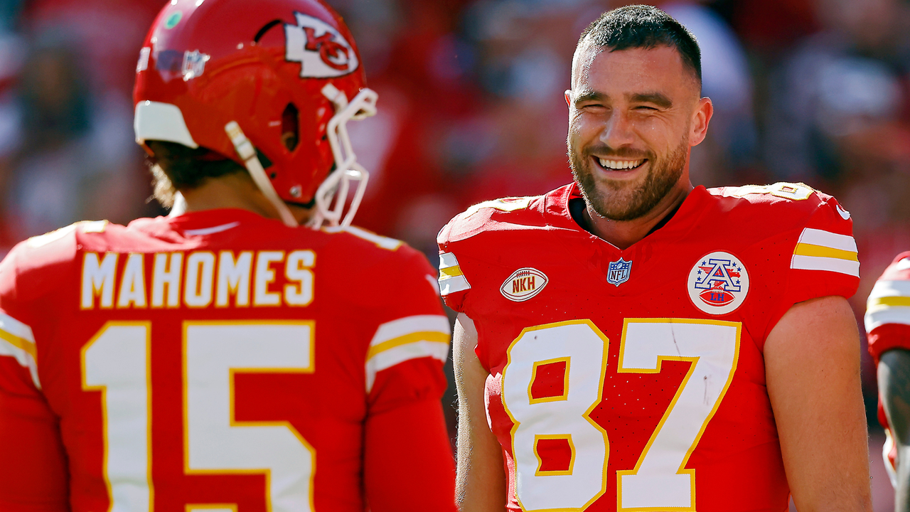 Travis Kelce #87 and Patrick Mahomes #15 of the Kansas City Chiefs talk before the game against the Los Angeles Chargers at GEHA Field at Arrowhead Stadium on October 22, 2023 in Kansas City, Missouri.