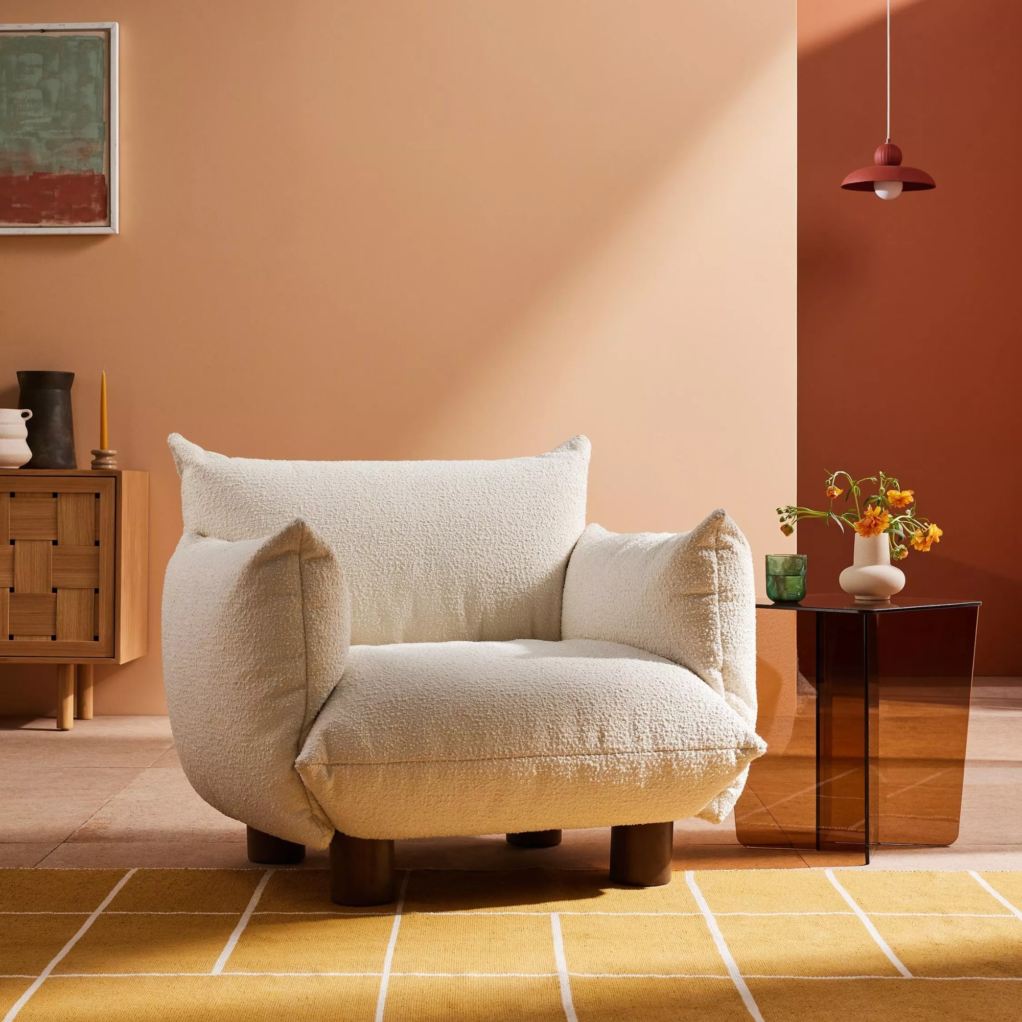 MADE Jude Armchair in a pink and red living room with a glass side table and a checked yellow rug