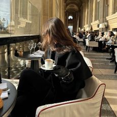 @emmaleger all black outfit drinking coffee