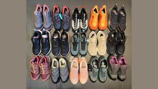 15 pairs of walking shoes lined up on tile floor, as tested by Susan Griffin