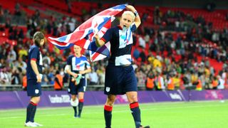 History of women's football: Scorer of the winning goal Stephanie Houghton of Team GB Women celebrates at the end of the match with a Union Jack flag as part of the 2012 London Olympic Summer Games at Wembley Stadium, London, England, UK on July 31st 2012 (Photo by AMA/Corbis via Getty Images)