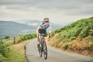 Female cyclist climbing out of the saddle
