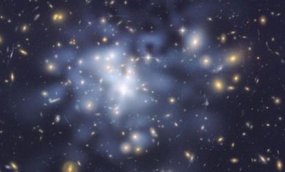 A NASA Hubble Space Telescope image of inferred dark matter that has been tinted blue, shows the concentration of dark matter at the center of a galaxy.