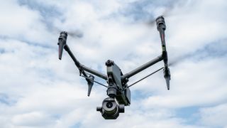 DJI Inspire 3 drone in flight against a blue sky