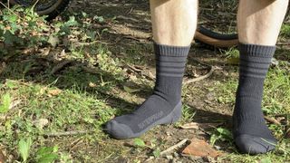 Man wearing the Black colored GripGrab Merino Lined Waterproof Winter socks