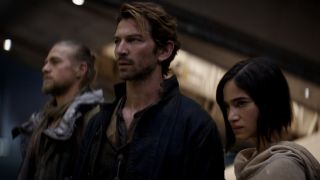 Charlie Hunnam, Michiel Huisman, and Sofia Boutella stand defiantly in a row in Rebel Moon.
