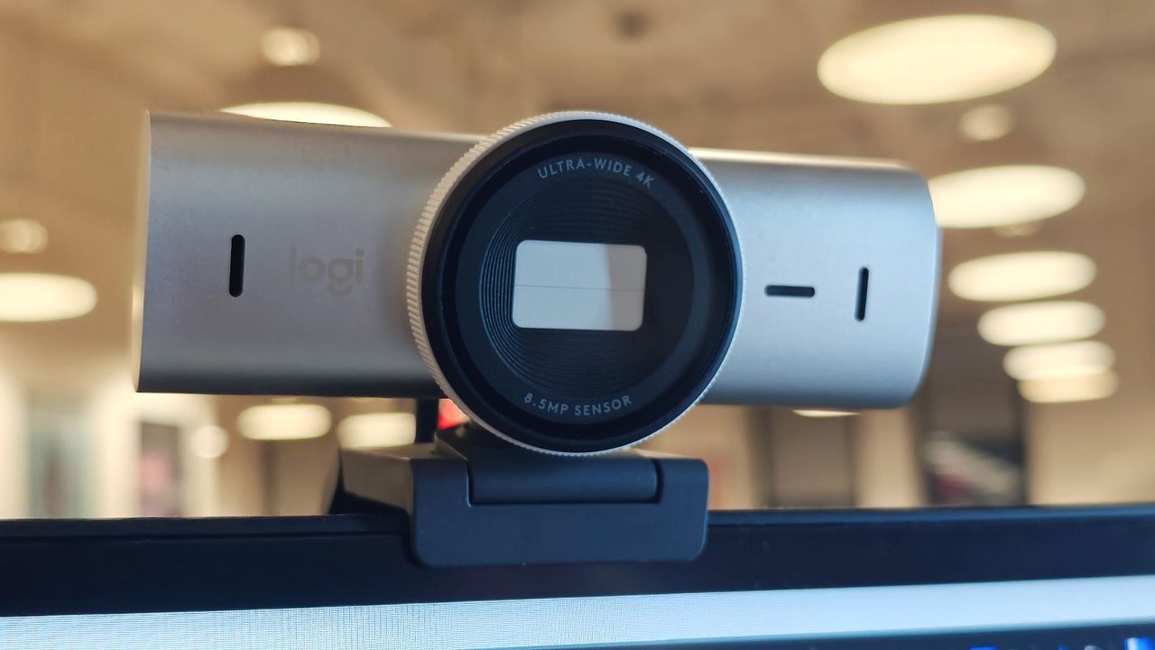 Logitech MX Brio 4K webcam mounted on a monitor angled downward with privacy shutter engaged