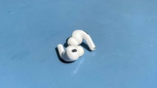 The AirPods Pro, lying on a blue table