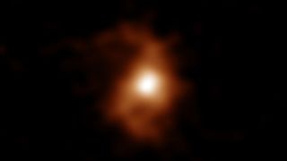 The blurry image of BRI 1335-0417, the oldest spiral galaxy in the universe, captured using radio emissions from carbon ions within the distant galaxy