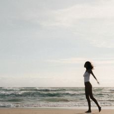 A woman standing on a beach