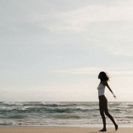 A woman standing on a beach
