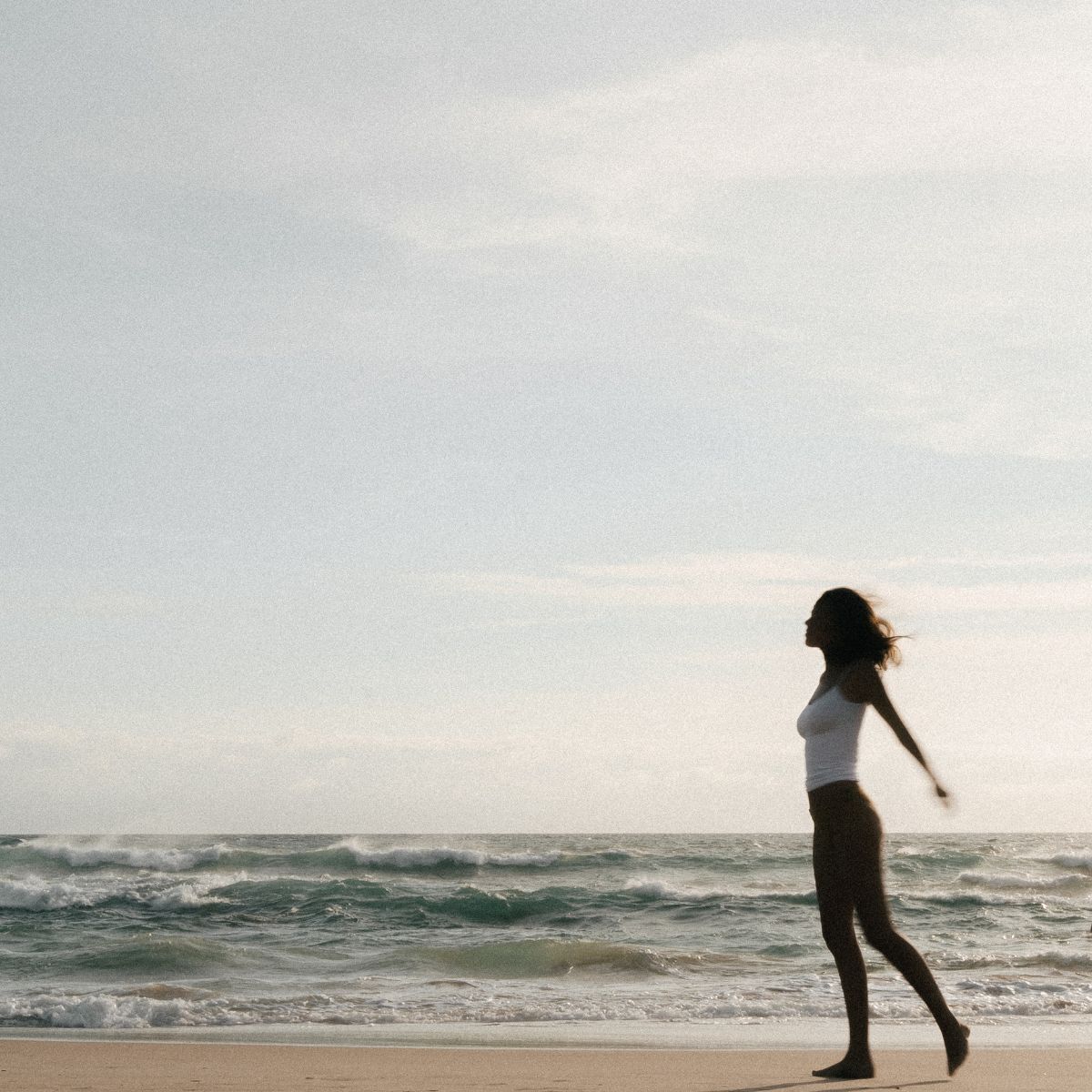 A woman standing on a beach