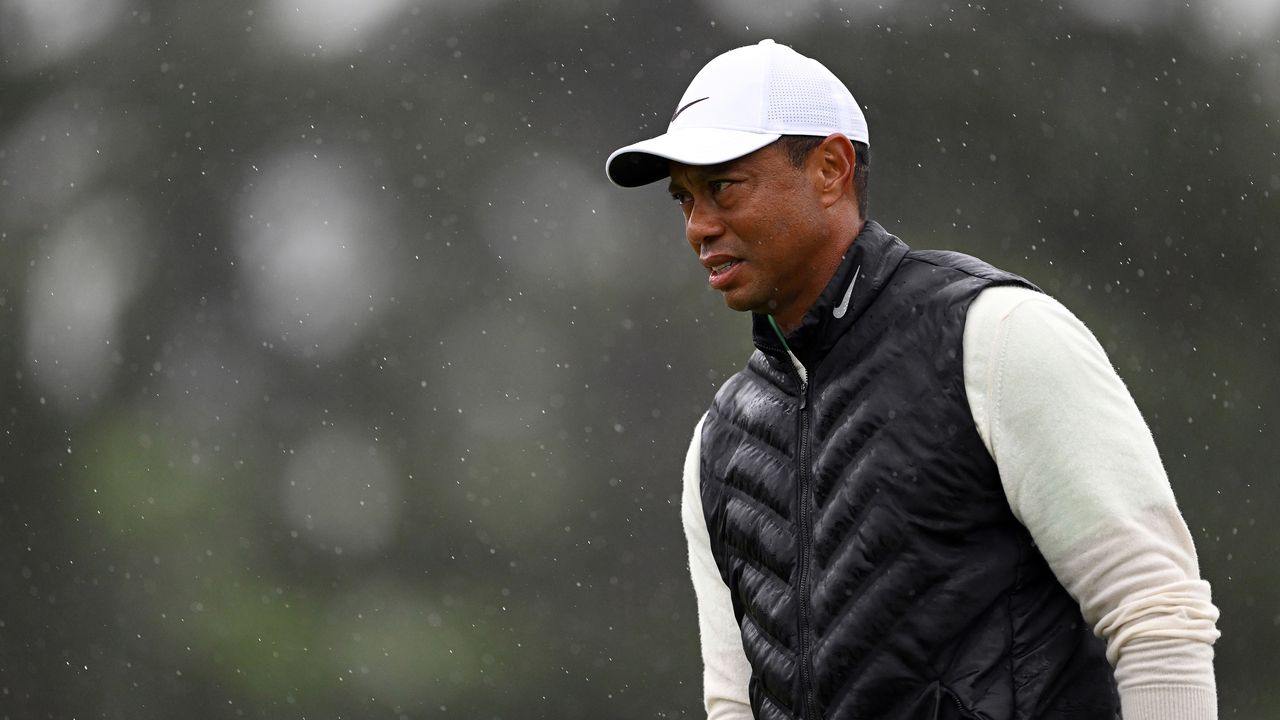 Tiger Woods of the United States looks on from the 18th green during the continuation of the weather delayed second round of the 2023 Masters Tournament at Augusta National Golf Club