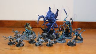 All of the new Tyranid models on a wooden table