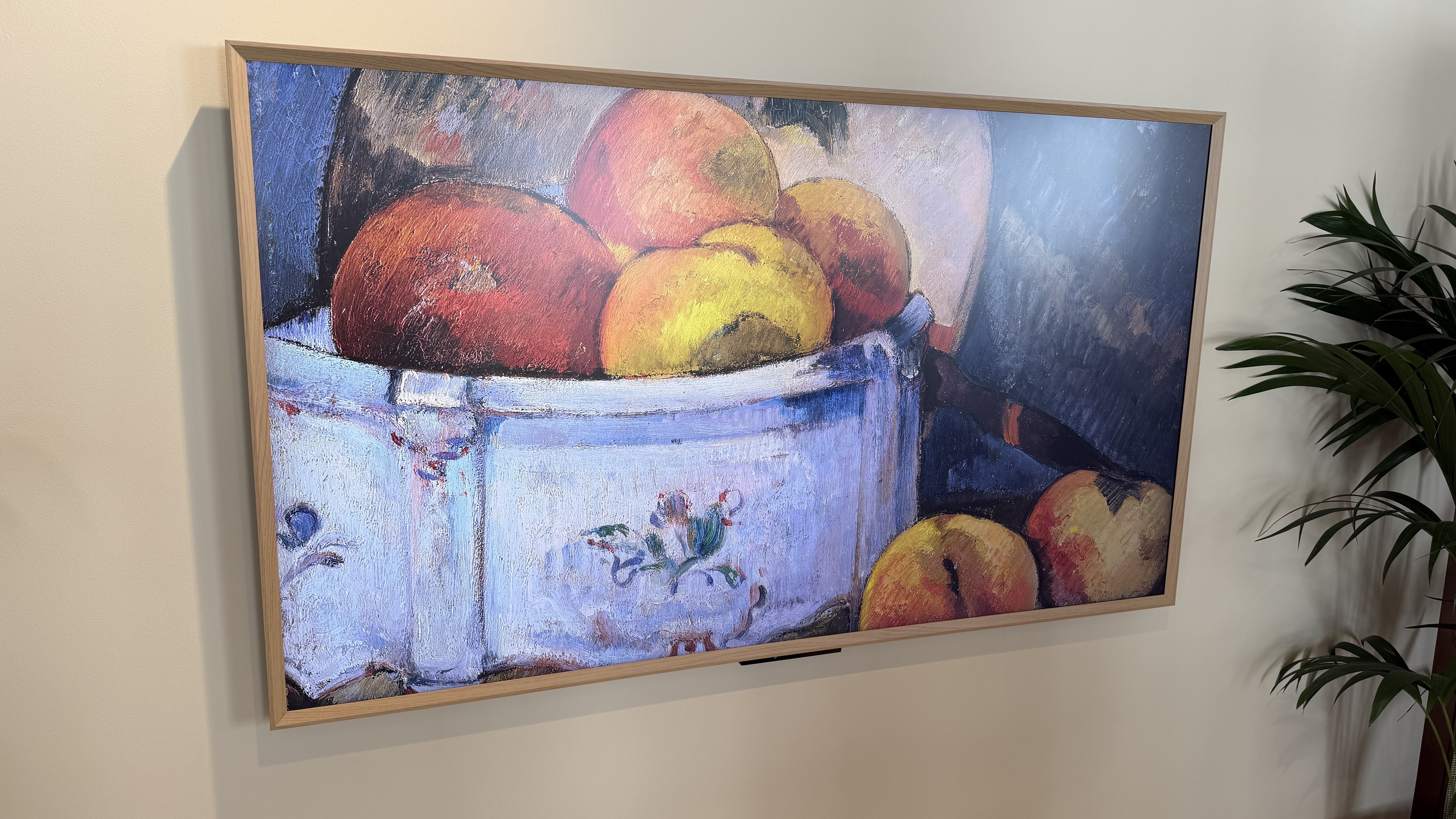 Amazon Ember Artline TV front left angle with art of peaches on screen 