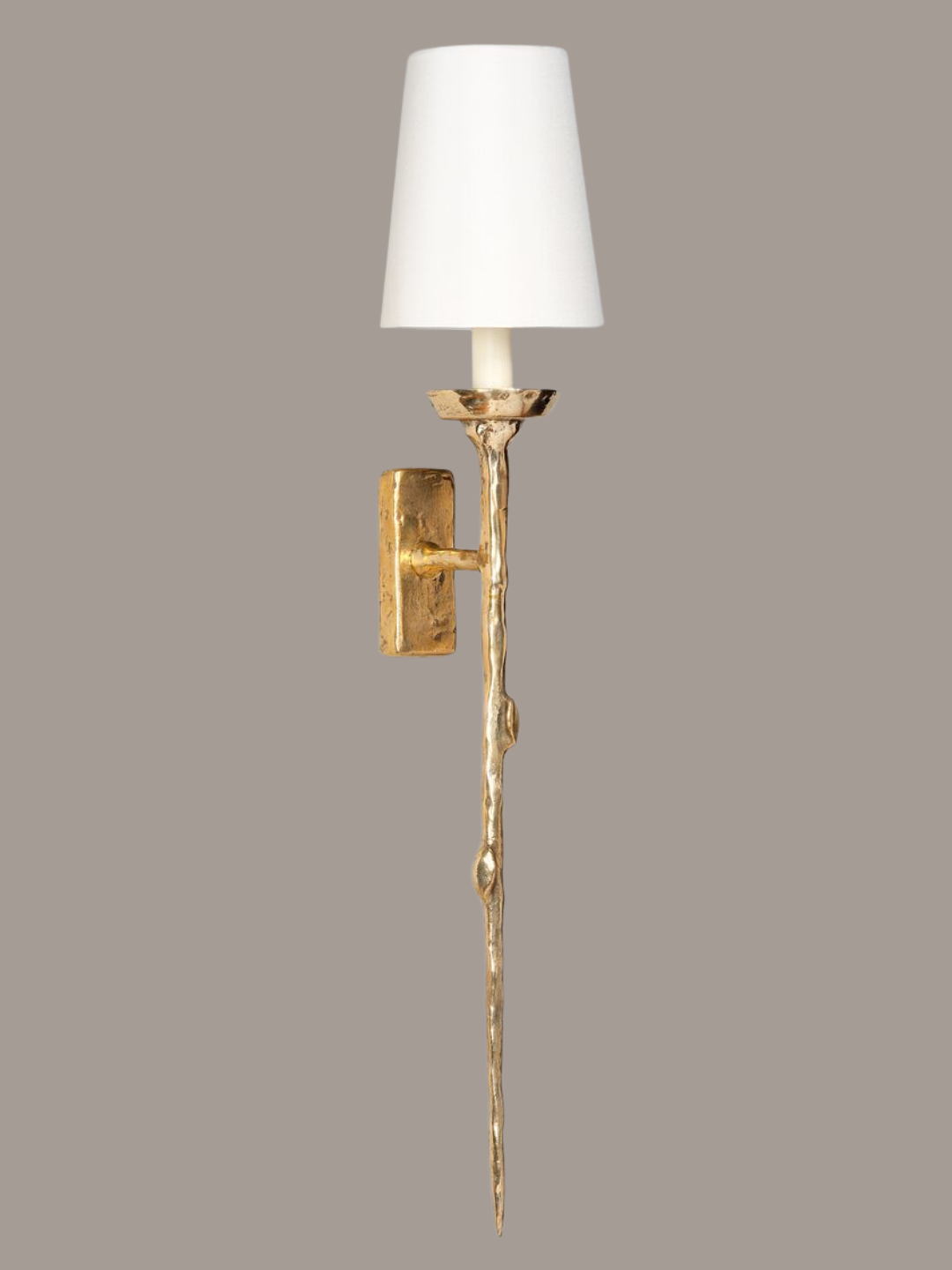 A white wall lamp with a gold textured stem from Vaughan