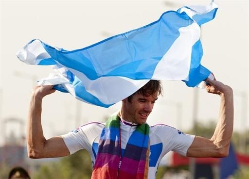 David Millar waves the Saltire after winning gold for Scotland