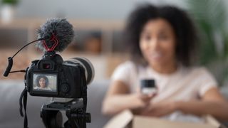 Best cameras for vlogging — a women sitting in front of a camera