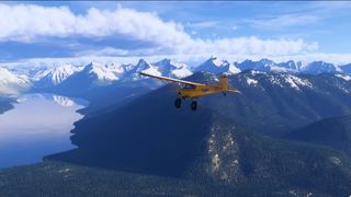 A screenshot of a yellow plane flying over Glacier, Montana, taken from an upcoming Microsoft Flight Simulator 2024 update.