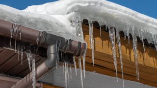 Exterior of house showing gutters and drains covered in icicles