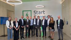 Start Campus and Schneider Electric employees stood in front of the Start Campus logo in Sines, Portugal. To the left of frame stands Robert Dunn, the CEO of Start Campus.