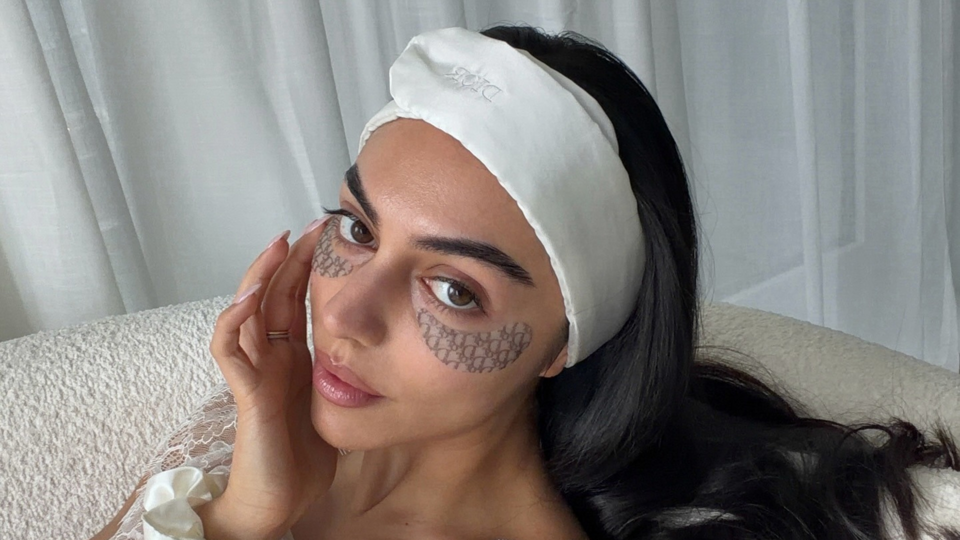A woman wearing skincare eye patches.